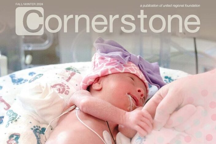 small-baby-being-held-on-a-blanket