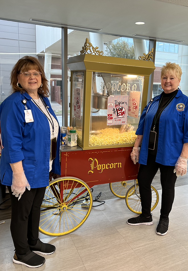 Two-femail-volunteers-serving-popcorn