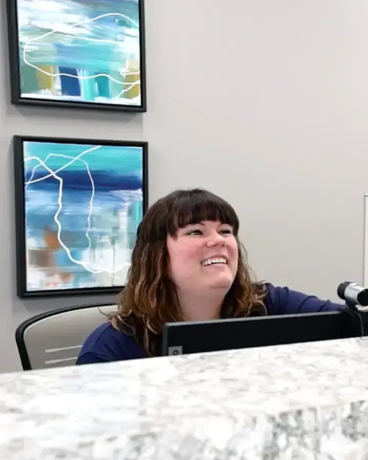 staff checking in patient at reception desk