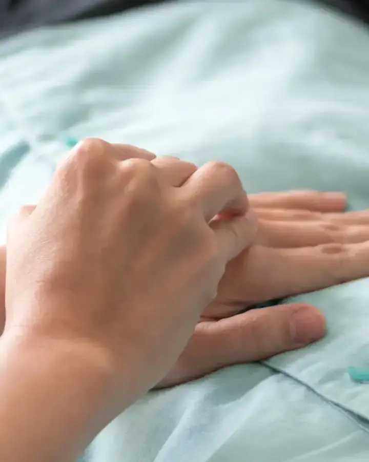 person putting hand on patient chest