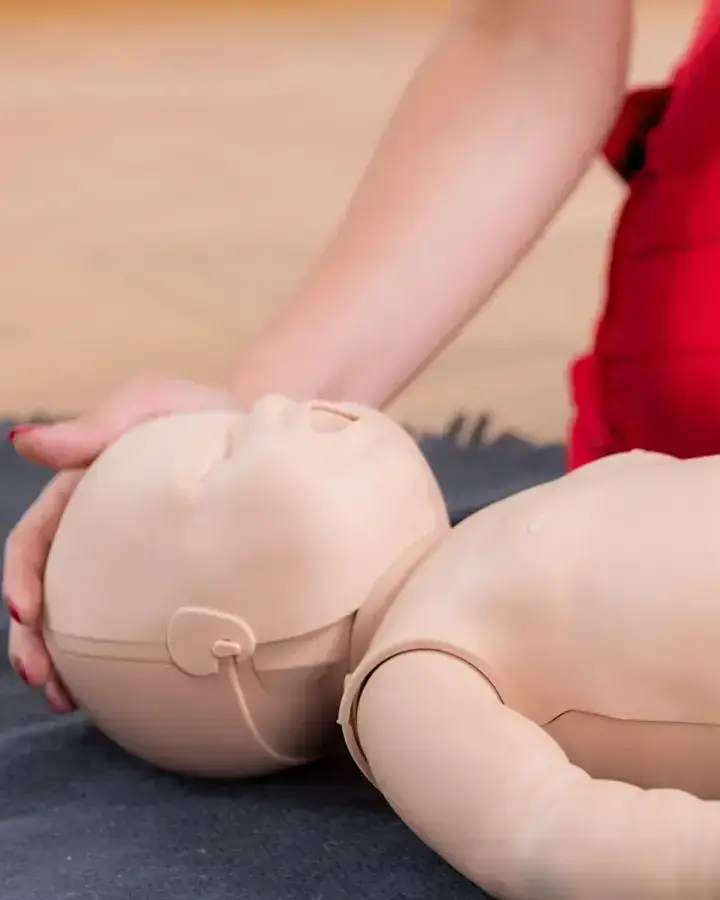 a woman is laying on the floor with her baby doll
