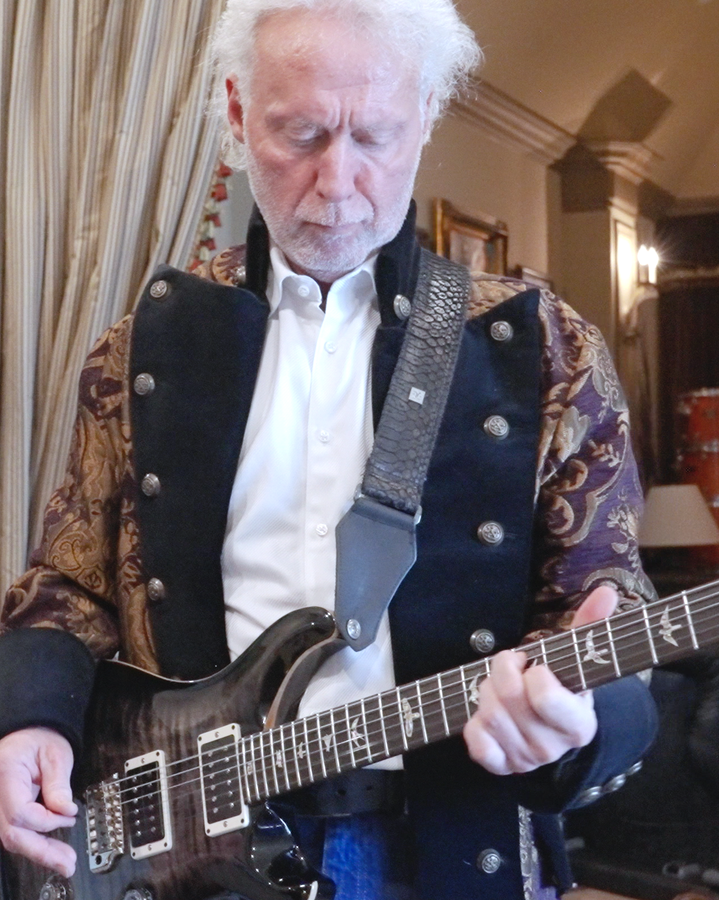 Older-man-playing-guitar-in-a-studio
