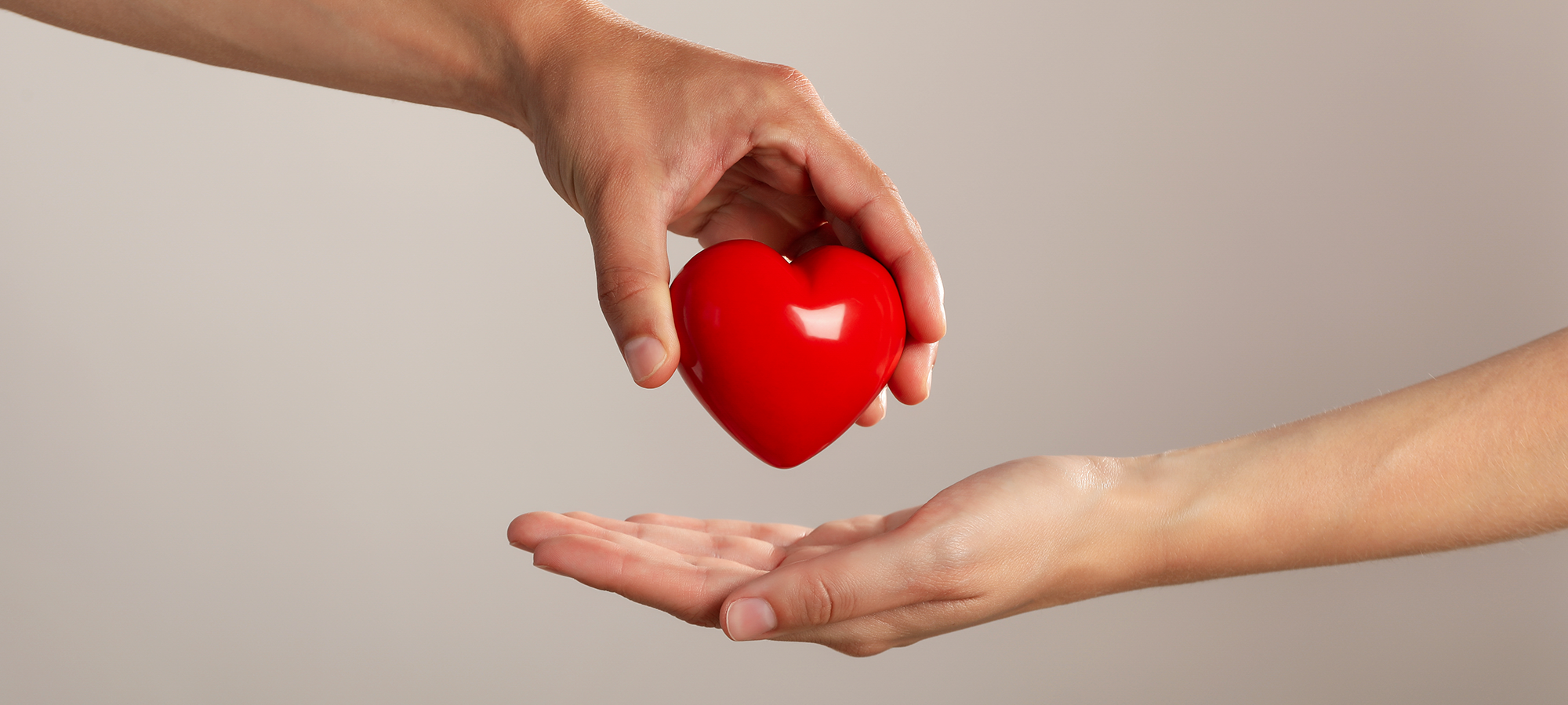 red-heart-being-handed-to-a-different-person