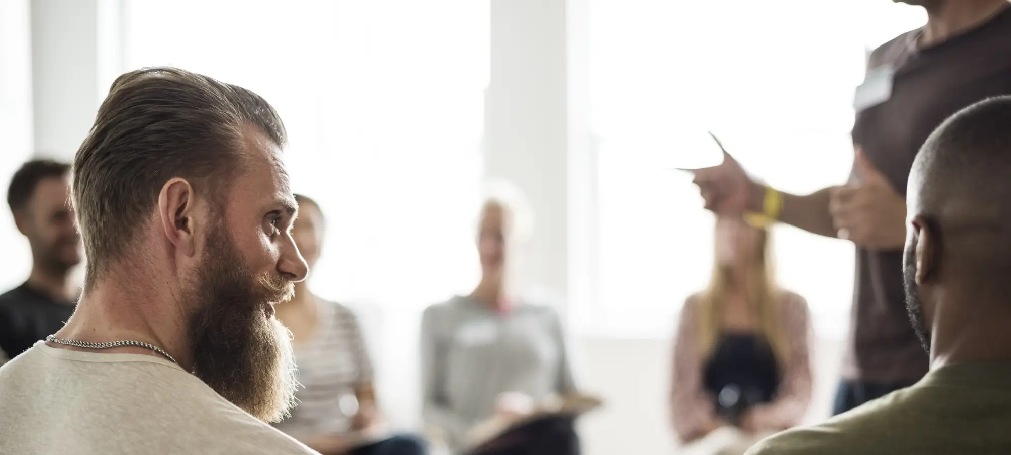 two men in group discussion