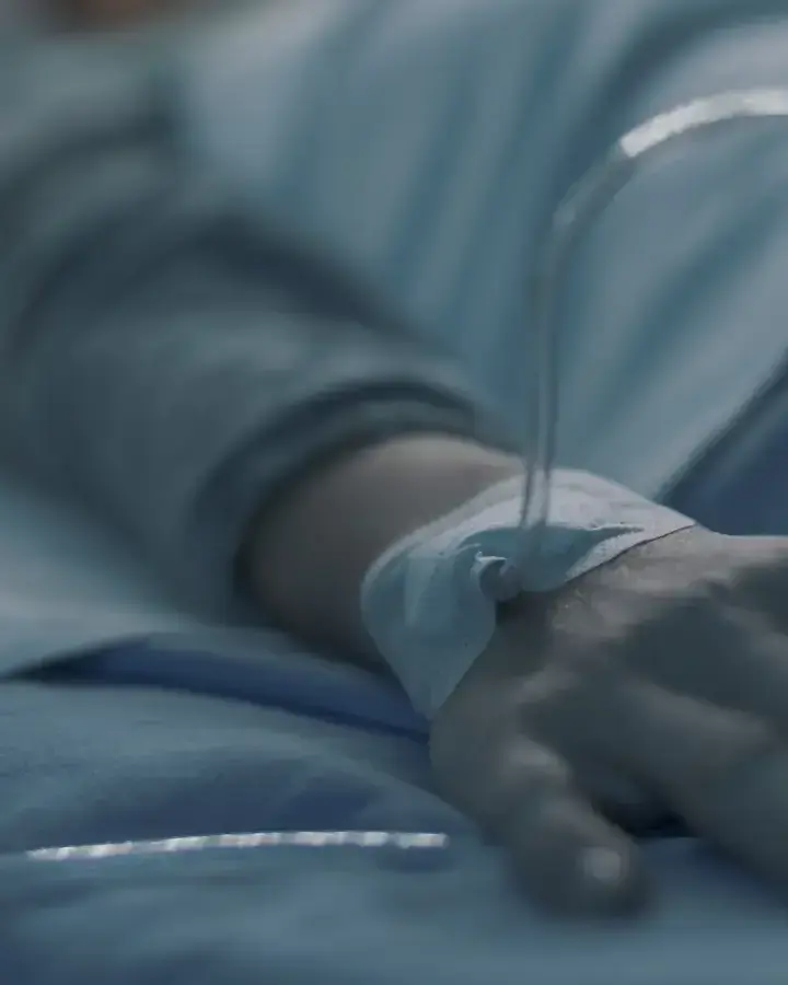 a person in a hospital bed with saline