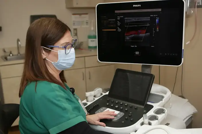 nurse in mask at desk 