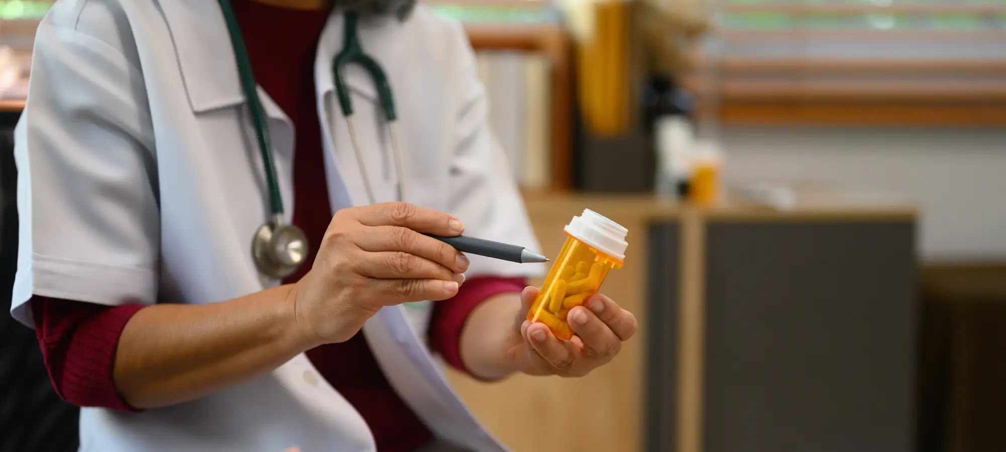 a doctor is holding a prescription bottle