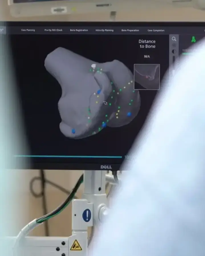 a man in a hospital room looking at a monitor